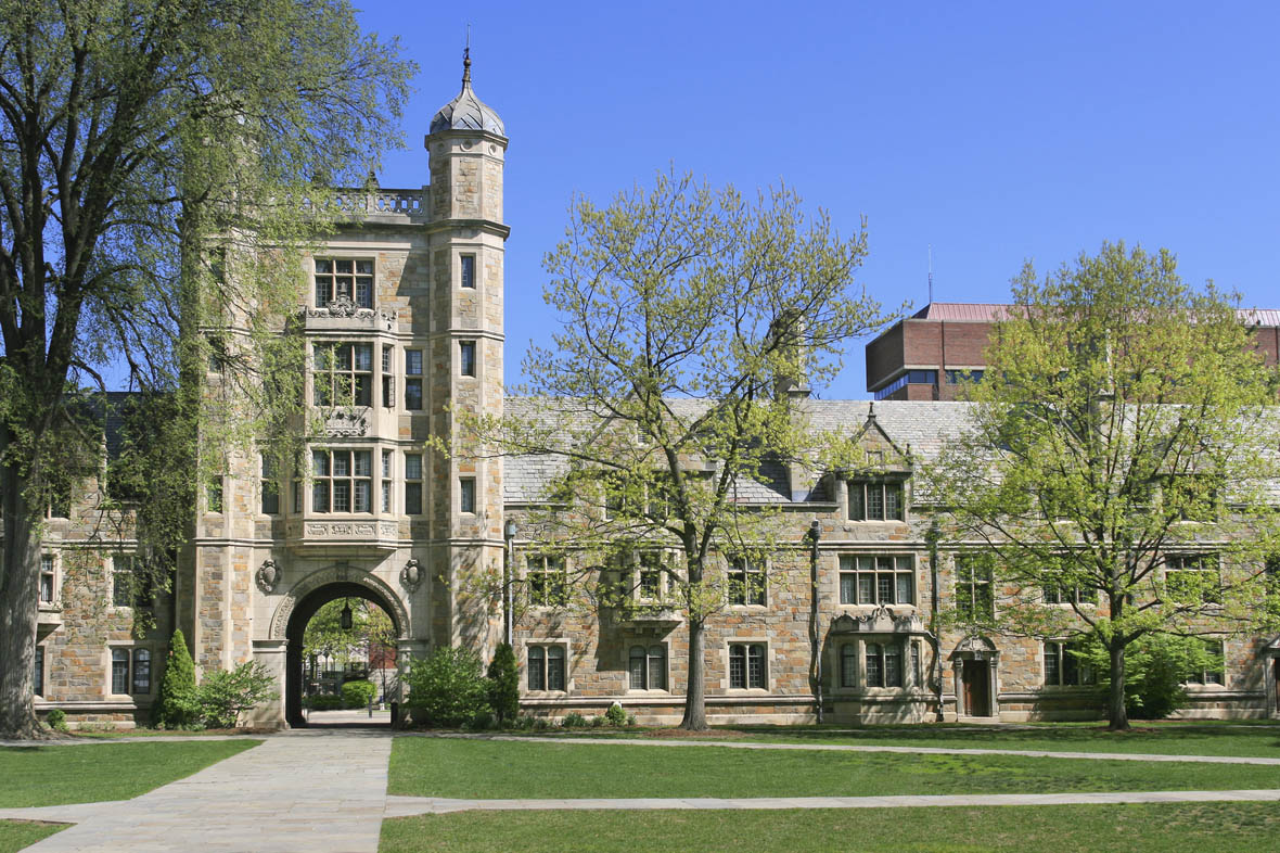 University of Michigan Law School, Ann Arbor, Michigan, USA. The image taken on a spring morning from the quadrangle of the Law School  with green grass and trees in forground. The Law school is designed in the English Gothic style. Clear blue sky is in background. HDR photorealistic image.