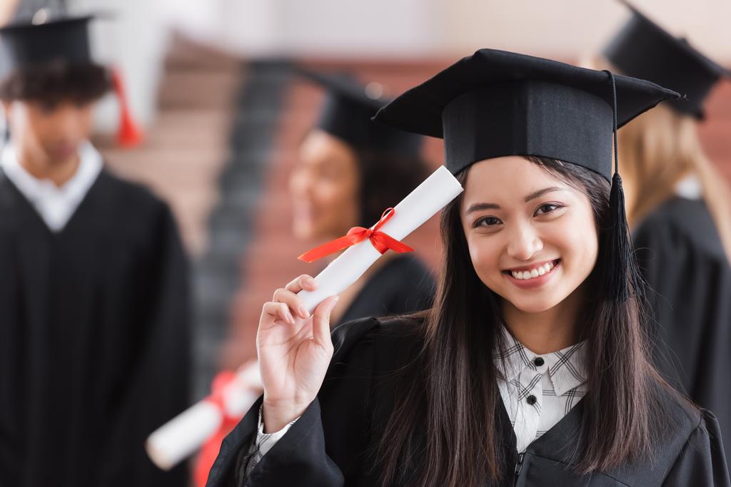 stock photo asian graduate cap smiling holding